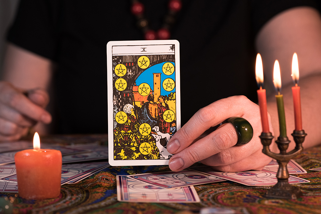 Close up female hands holding tarot cards. Fortuneteller. Witchcraft